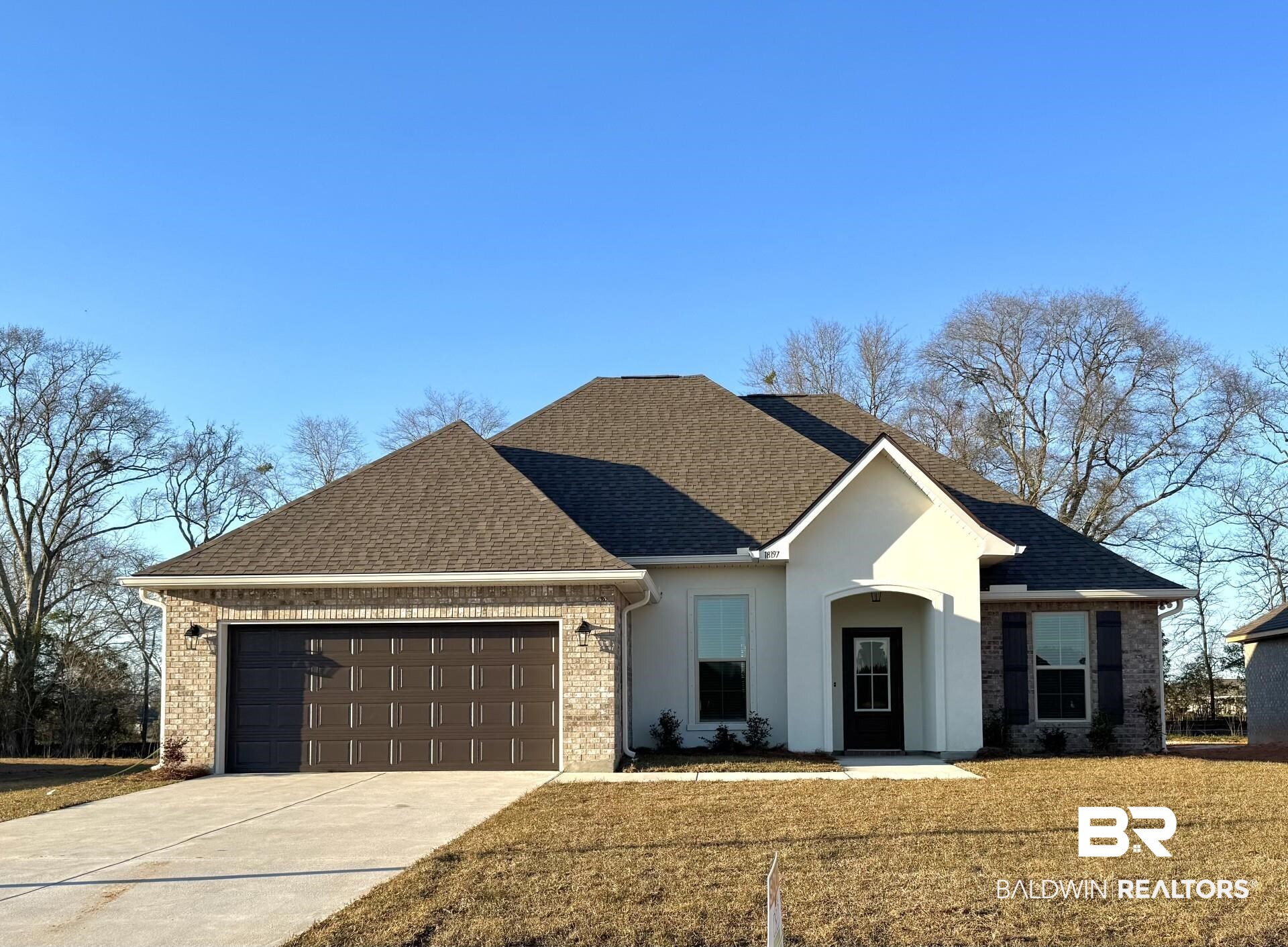 18197 Aden Drive Robertsdale, AL 36567 - Photo 1 of 3 View of front facade with a shingled roof, concrete driveway, and a front lawn