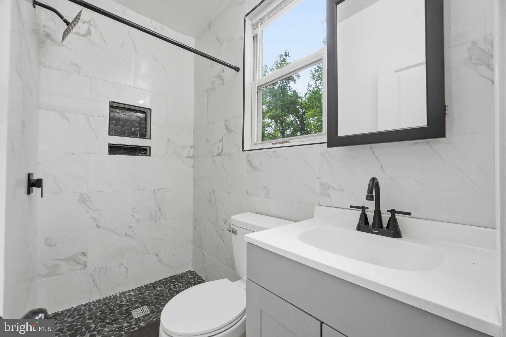 5906 Berwyn Road College Park, MD 20740 - Photo 23 of 46 a bathroom with a sink a toilet and shower