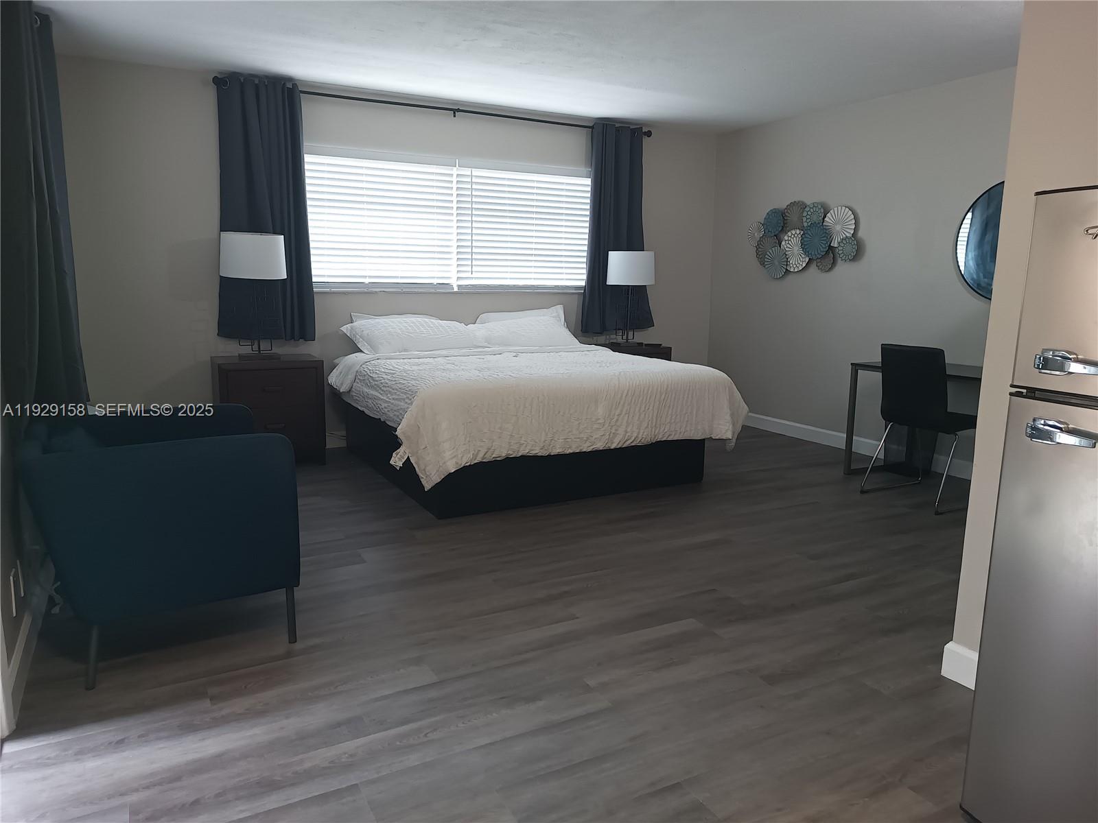 507 Southeast 18th Street, Unit 5 Fort Lauderdale, FL 33316 - Photo 2 of 5 a bedroom with a bed and wooden floor