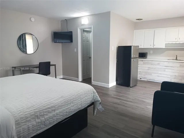 a bedroom with a bed and a mirror