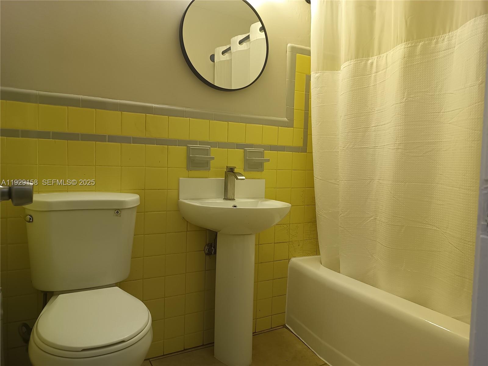 507 Southeast 18th Street, Unit 5 Fort Lauderdale, FL 33316 - Photo 4 of 5 a bathroom with a toilet sink and mirror