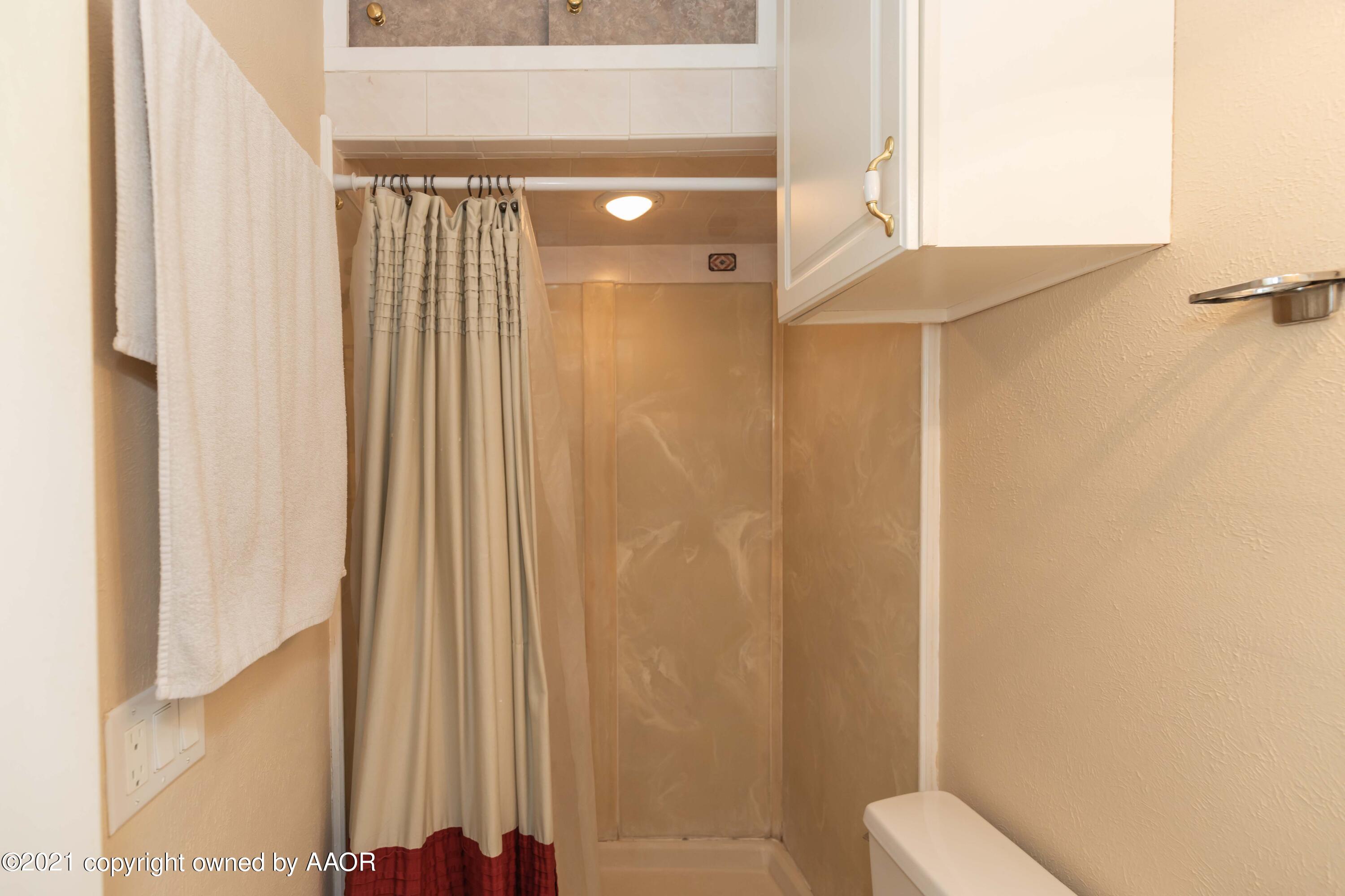 3817 South Hughes Street Amarillo, TX 79110 - Photo 23 of 36 a bathroom with a shower and a toilet