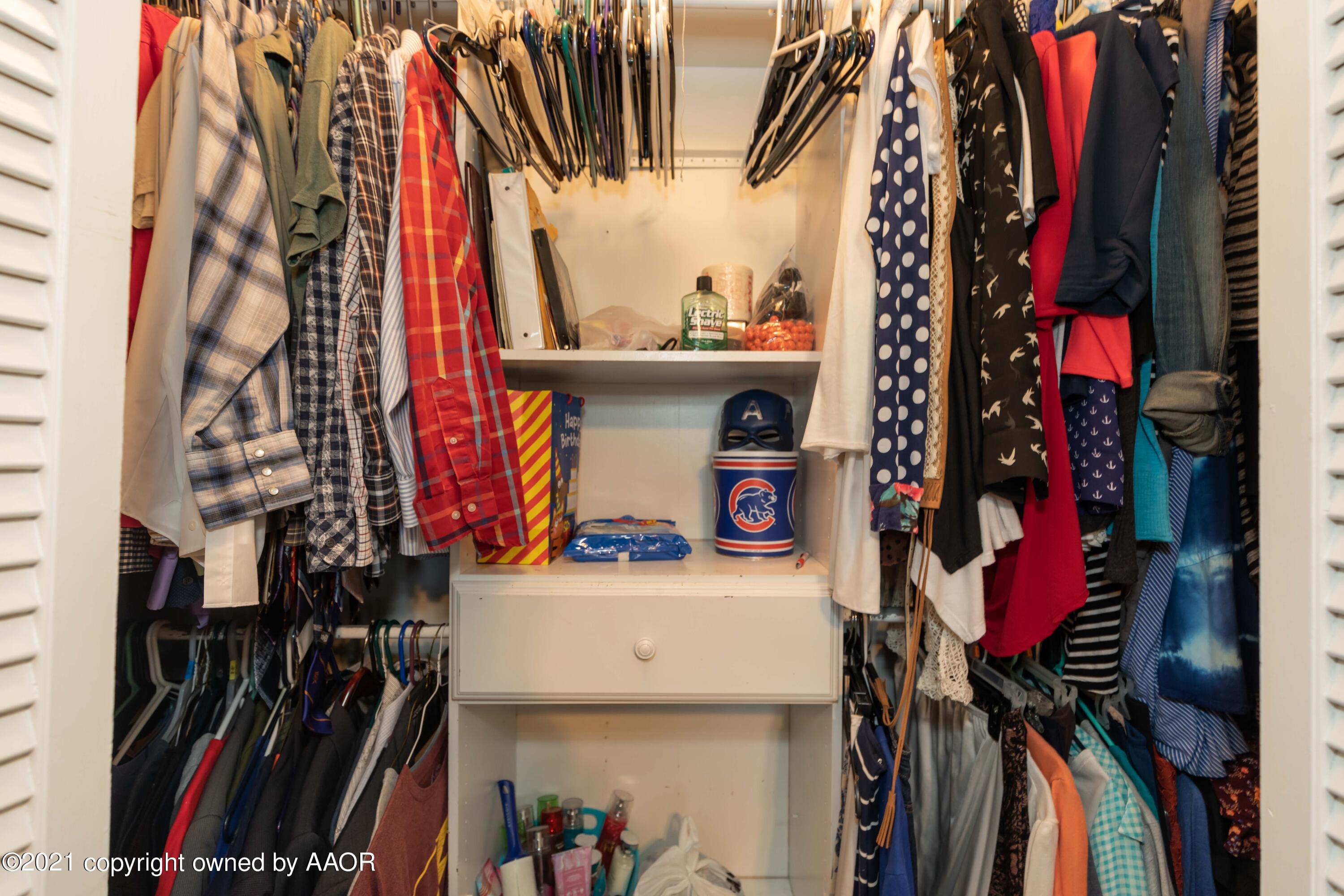 3817 South Hughes Street Amarillo, TX 79110 - Photo 24 of 36 a view of walk in closet with clothes and shoes
