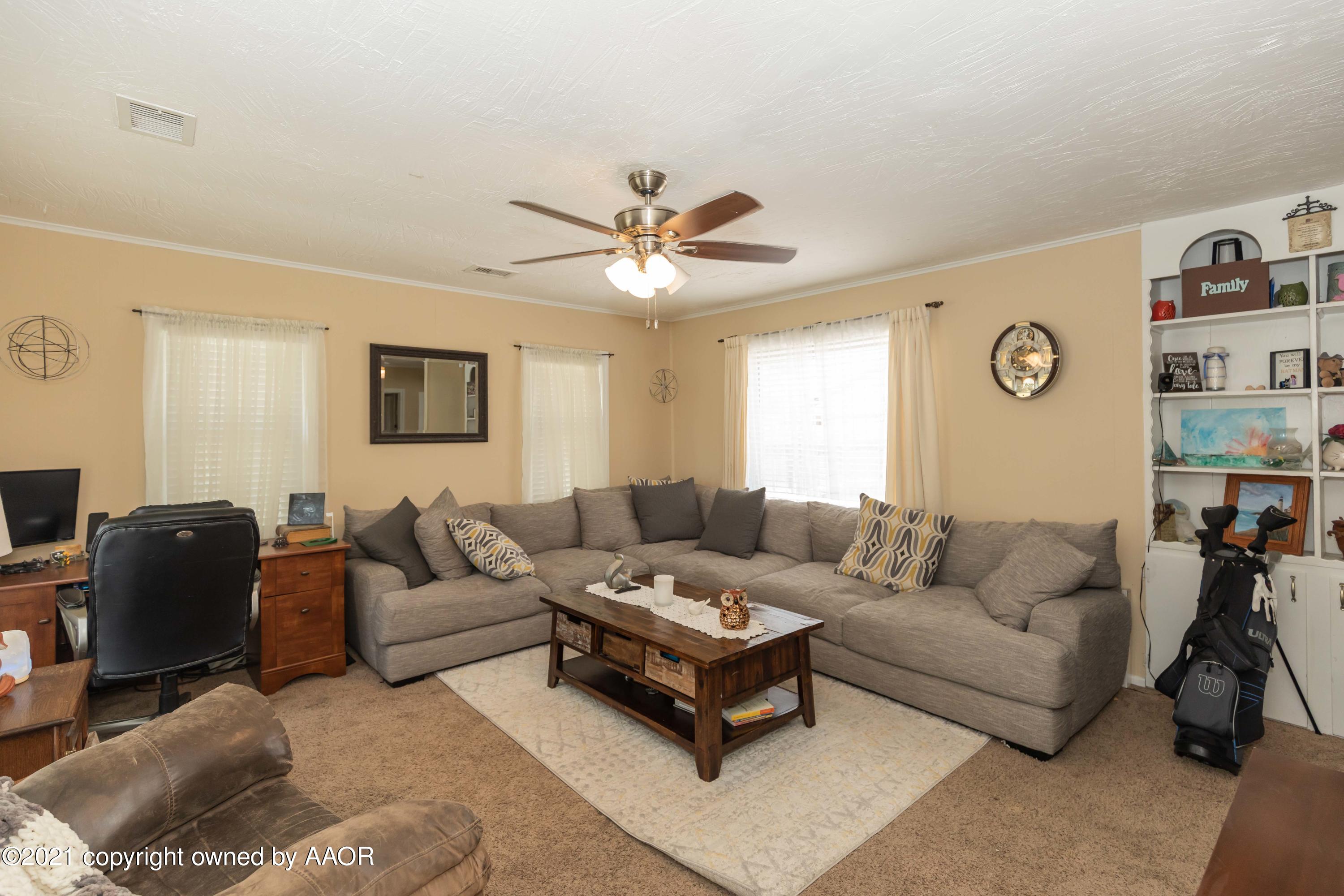 3817 South Hughes Street Amarillo, TX 79110 - Photo 4 of 36 a living room with furniture and a large window
