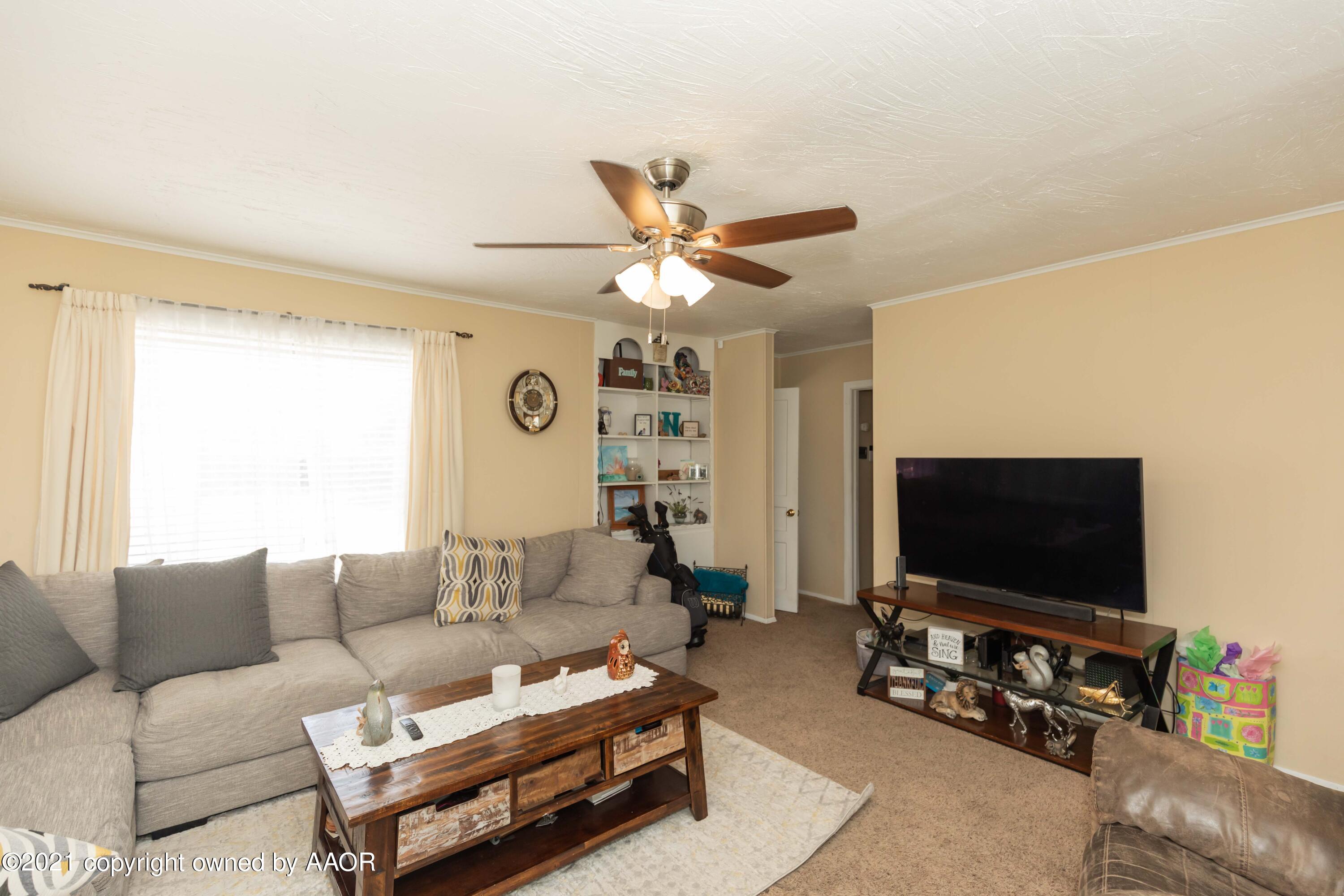 3817 South Hughes Street Amarillo, TX 79110 - Photo 6 of 36 a living room with furniture and a flat screen tv