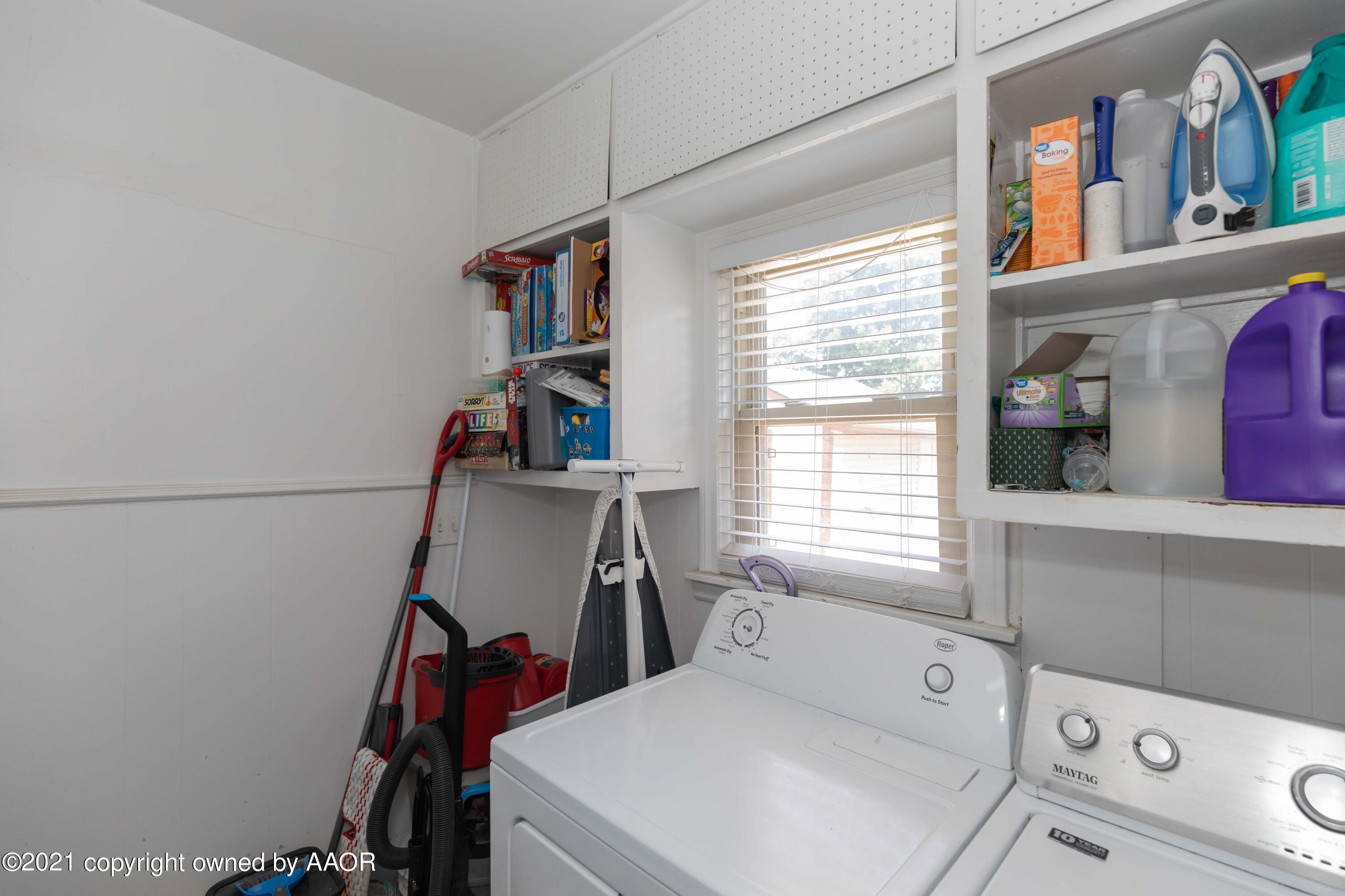 3817 South Hughes Street Amarillo, TX 79110 - Photo 7 of 36 a view of storage and utility room with washer and dryer