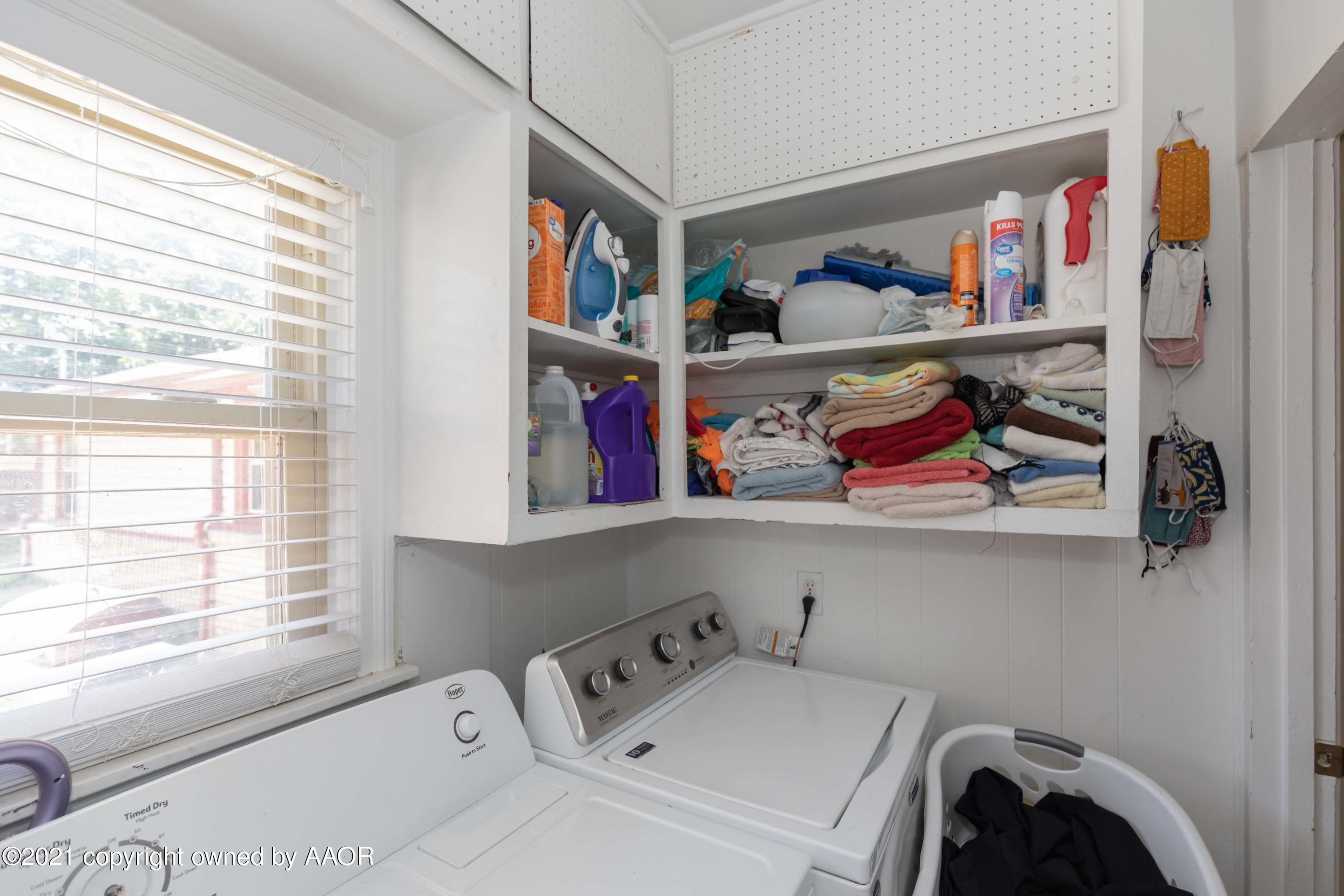3817 South Hughes Street Amarillo, TX 79110 - Photo 8 of 36 a utility room with dryer washer and a window