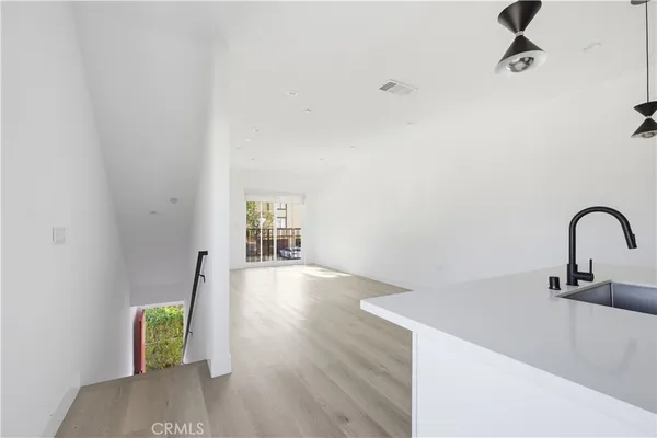 a close view of a sink a faucet and appliance in the kitchen