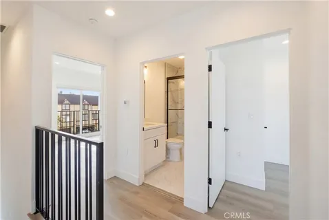 a view of a hallway with wooden floor and doors