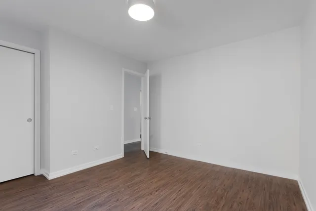 a view of an empty room and wooden floor