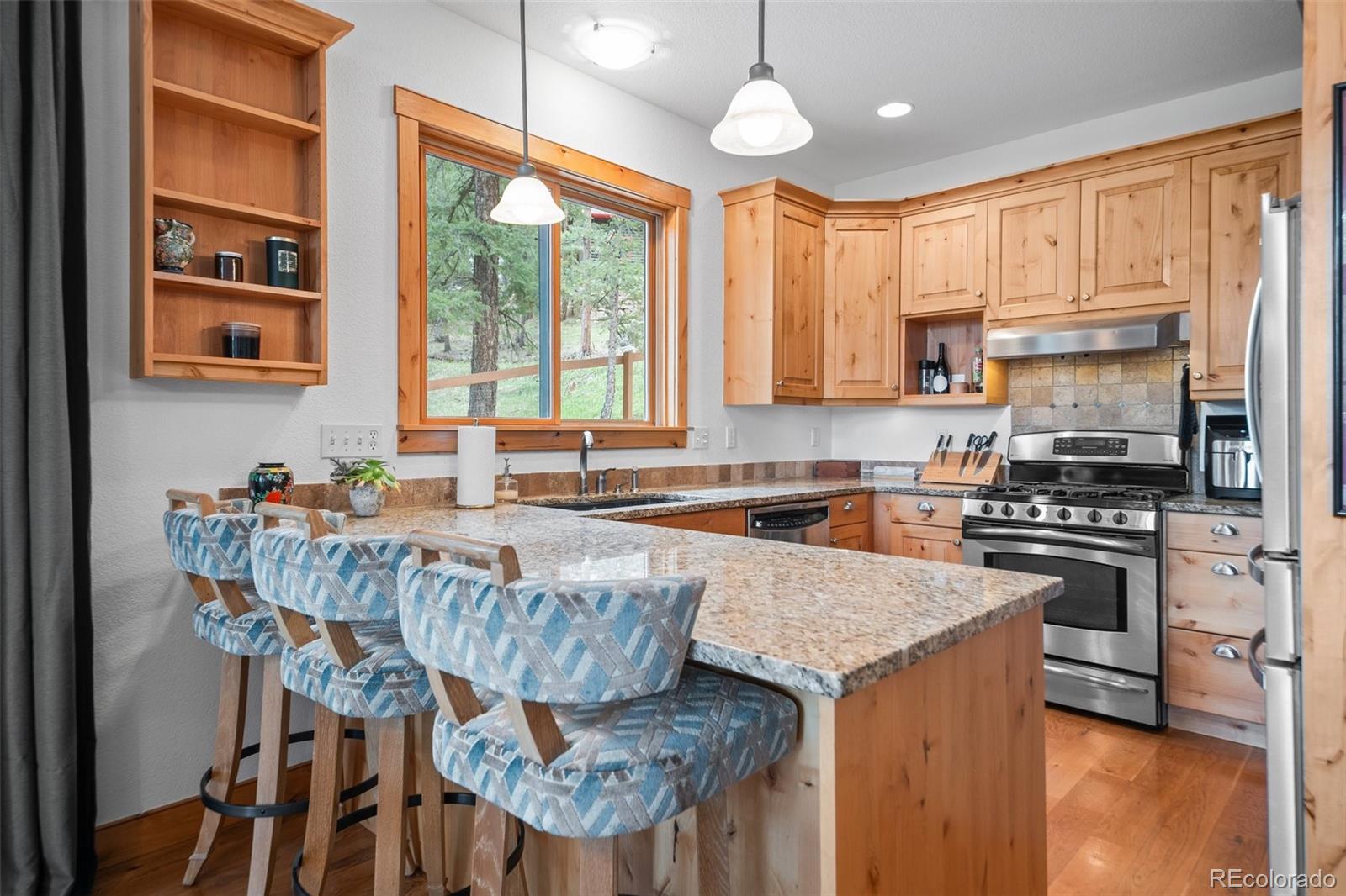 27711 Moffat Road Evergreen, CO 80439 - Photo 11 of 30 a kitchen with granite countertop a stove a sink and a refrigerator