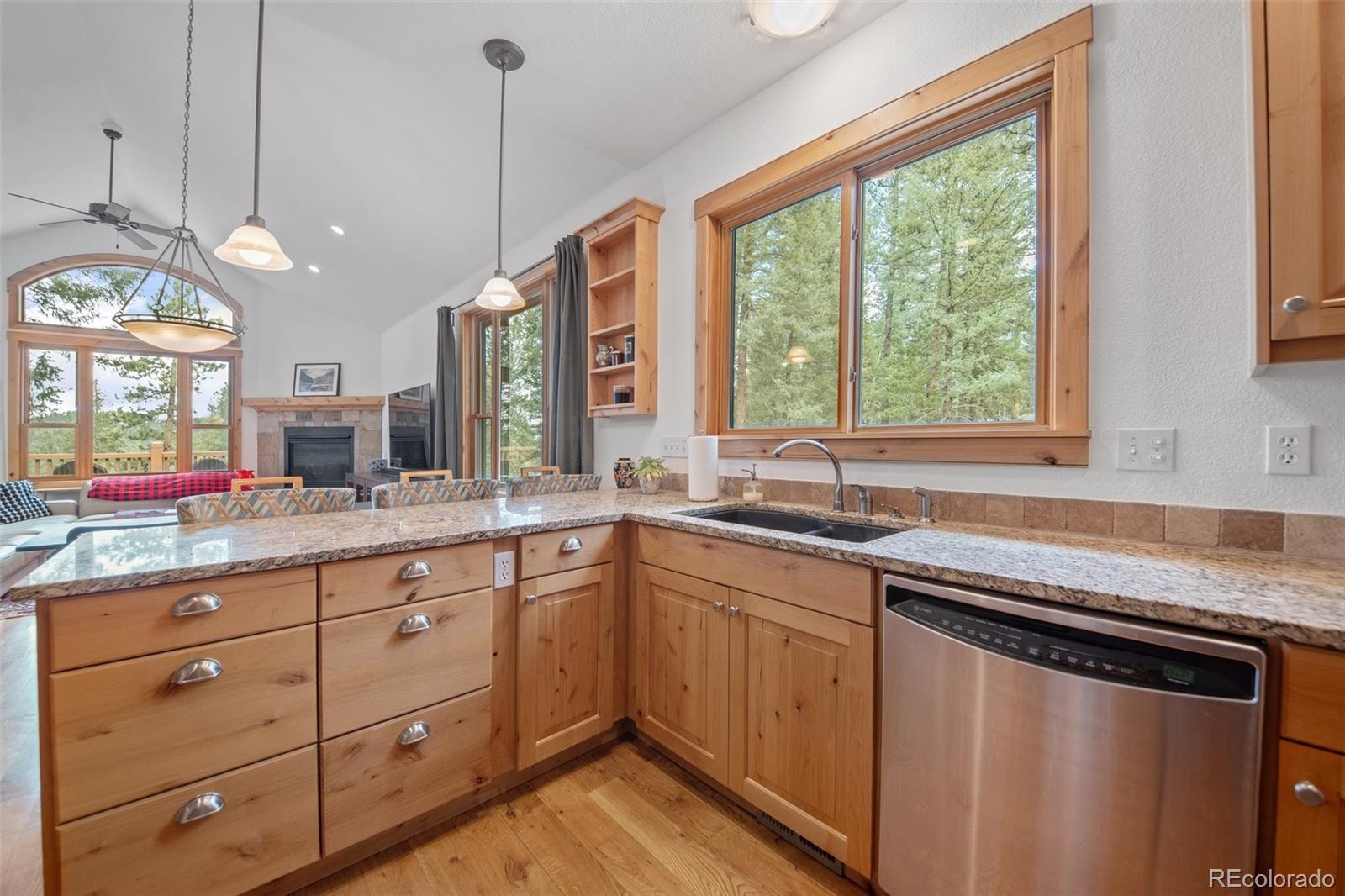 27711 Moffat Road Evergreen, CO 80439 - Photo 12 of 30 a kitchen with sink stove and cabinets