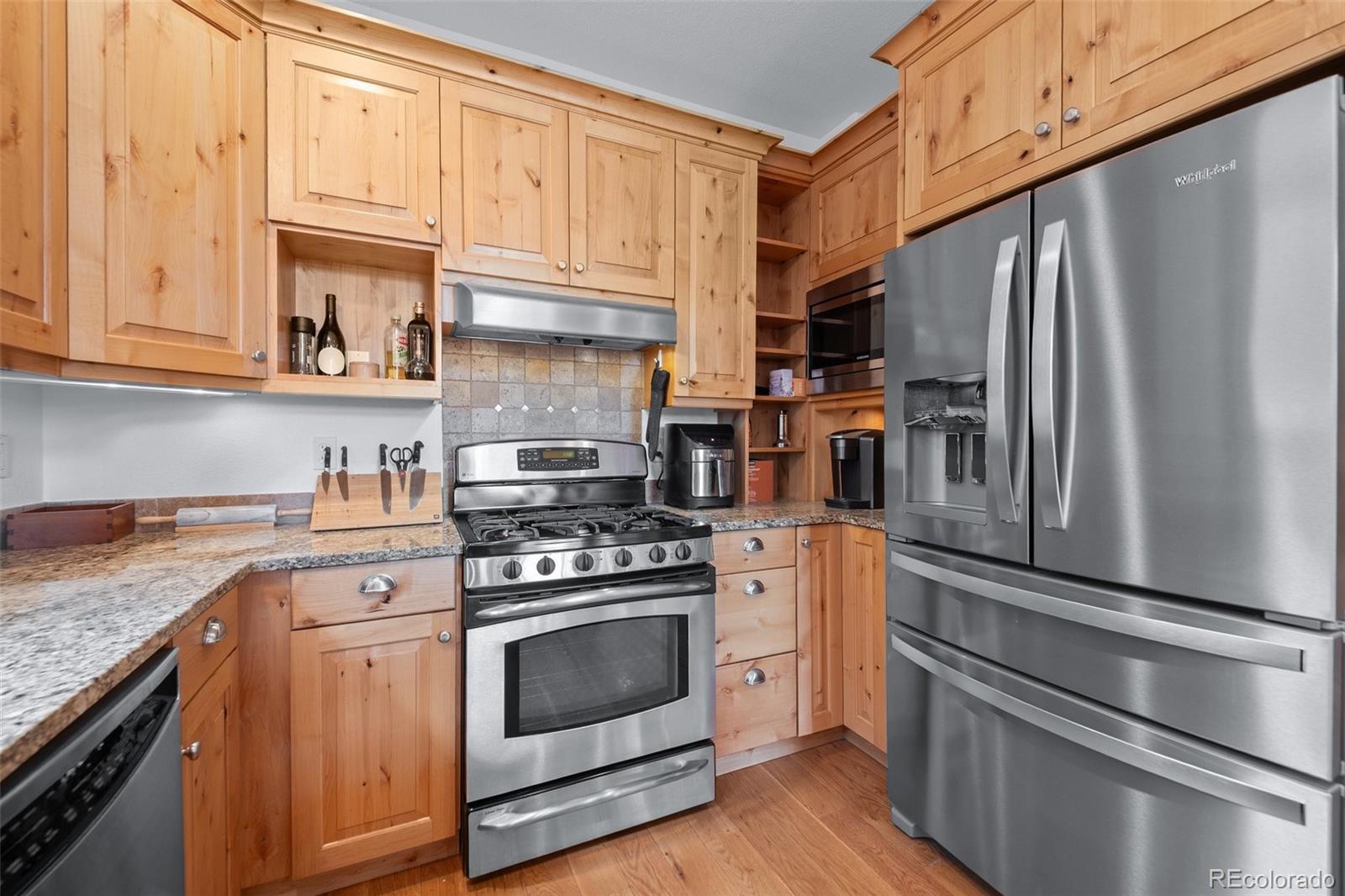 27711 Moffat Road Evergreen, CO 80439 - Photo 13 of 30 a kitchen with white cabinets and stainless steel appliances