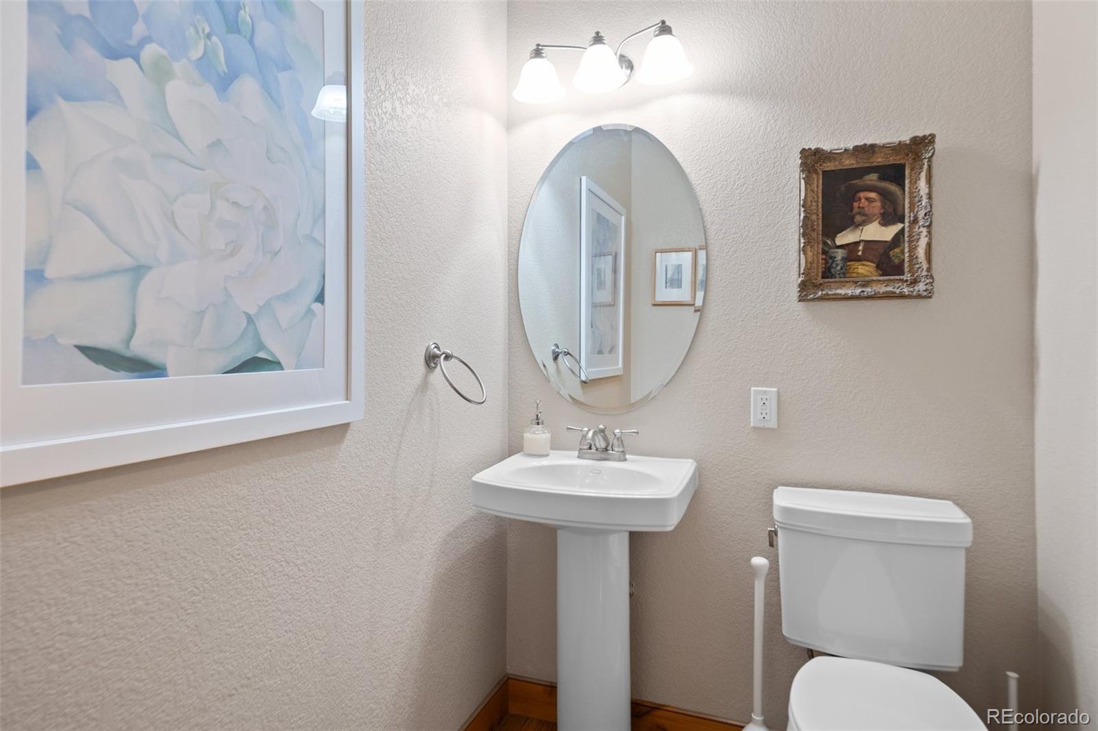 27711 Moffat Road Evergreen, CO 80439 - Photo 17 of 30 a bathroom with a toilet sink and mirror