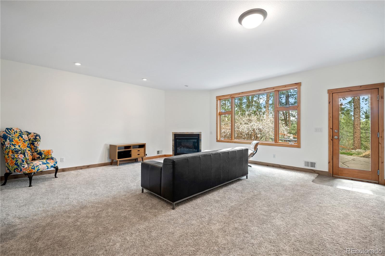 27711 Moffat Road Evergreen, CO 80439 - Photo 19 of 30 a living room with furniture window and a flat screen tv