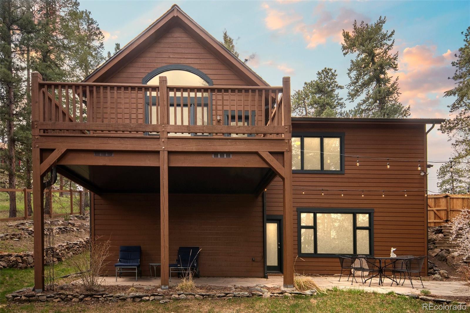 27711 Moffat Road Evergreen, CO 80439 - Photo 2 of 30 a front view of a house with a porch