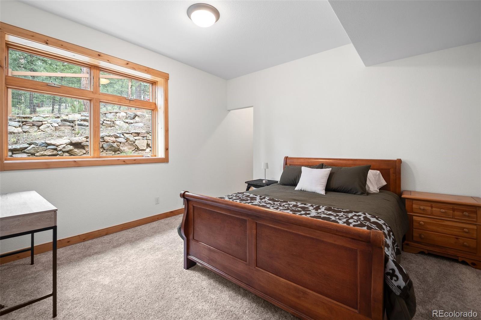 27711 Moffat Road Evergreen, CO 80439 - Photo 21 of 30 a bedroom with a bed and a window