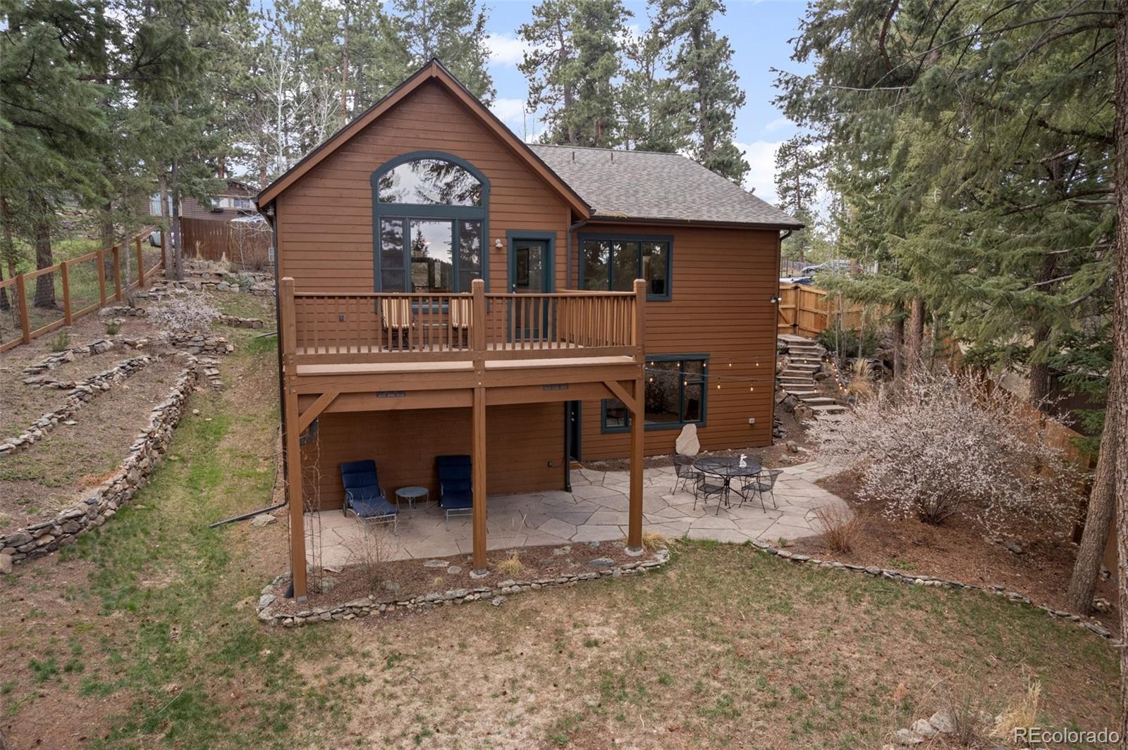 27711 Moffat Road Evergreen, CO 80439 - Photo 28 of 30 a view of a house with a yard and large tree