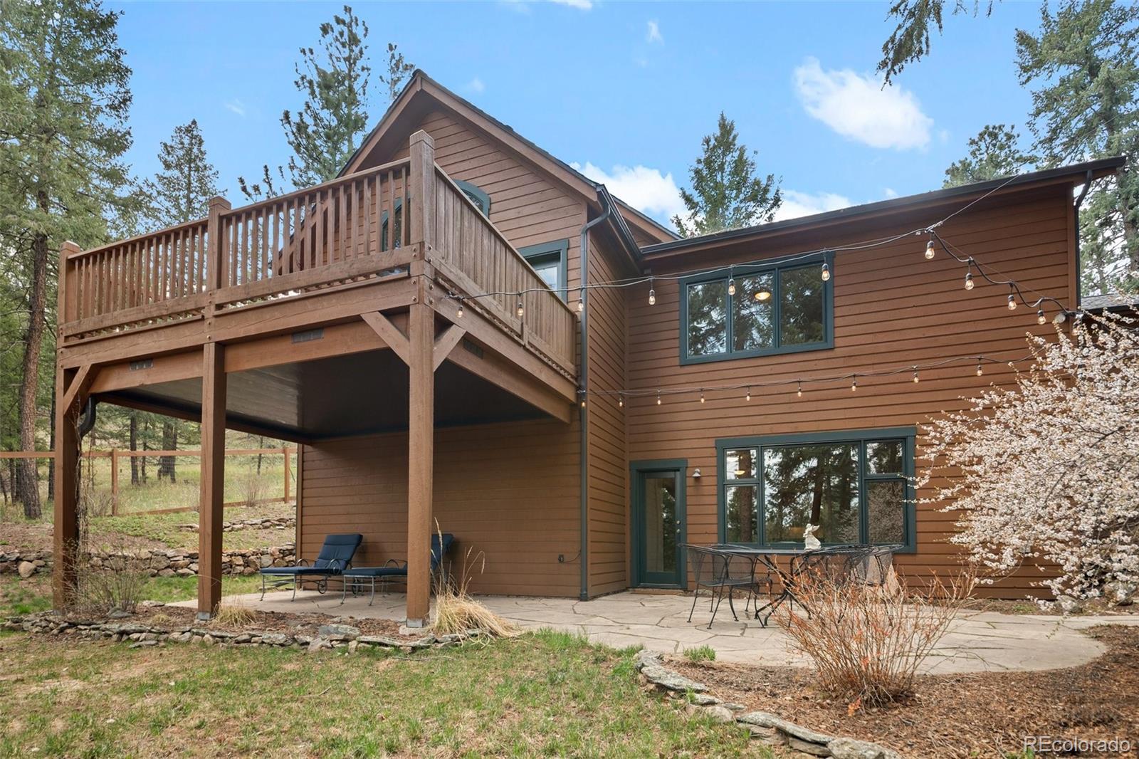 27711 Moffat Road Evergreen, CO 80439 - Photo 3 of 30 a view of a house with a porch