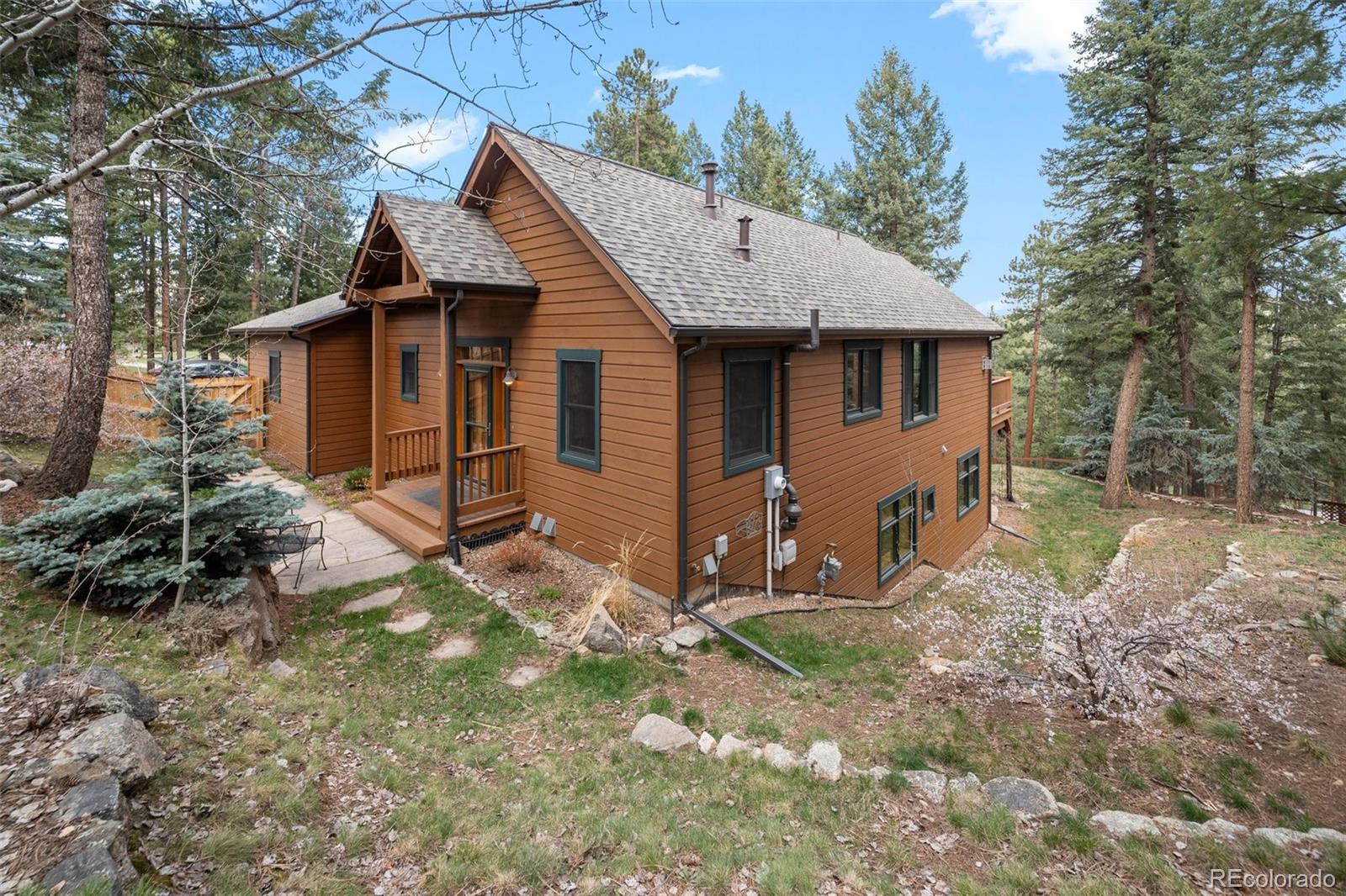 27711 Moffat Road Evergreen, CO 80439 - Photo 4 of 30 a view of a house with backyard and garden