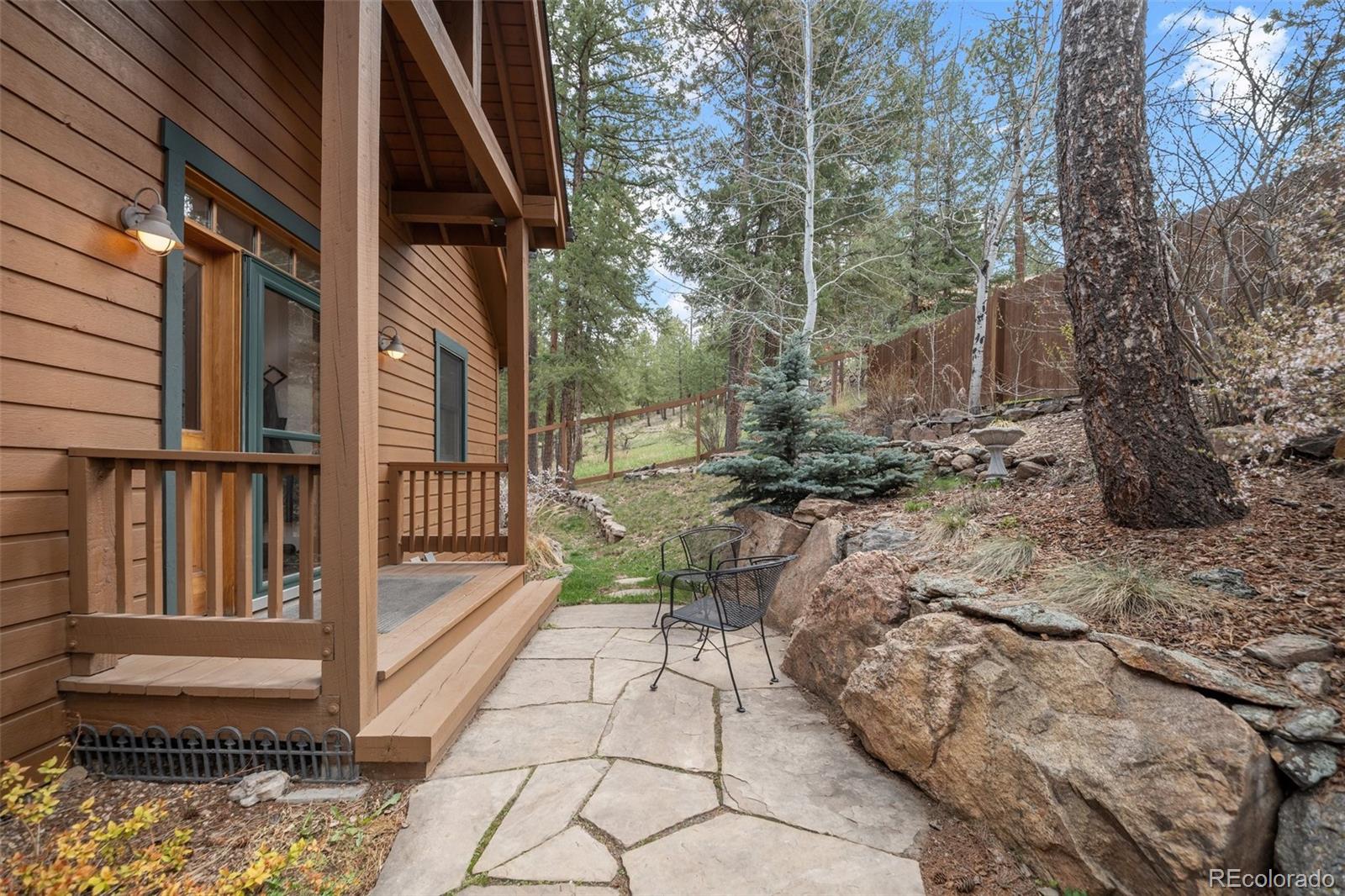 27711 Moffat Road Evergreen, CO 80439 - Photo 5 of 30 a view of a pathway with a bench