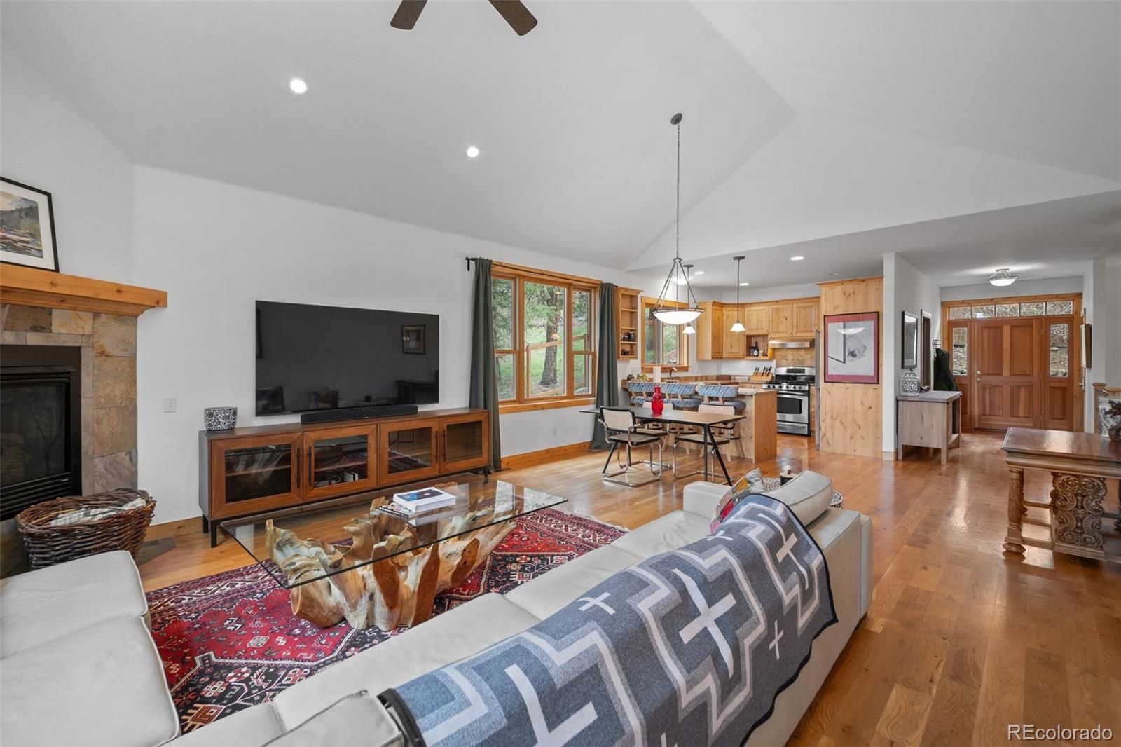 27711 Moffat Road Evergreen, CO 80439 - Photo 9 of 30 a living room with furniture and a flat screen tv