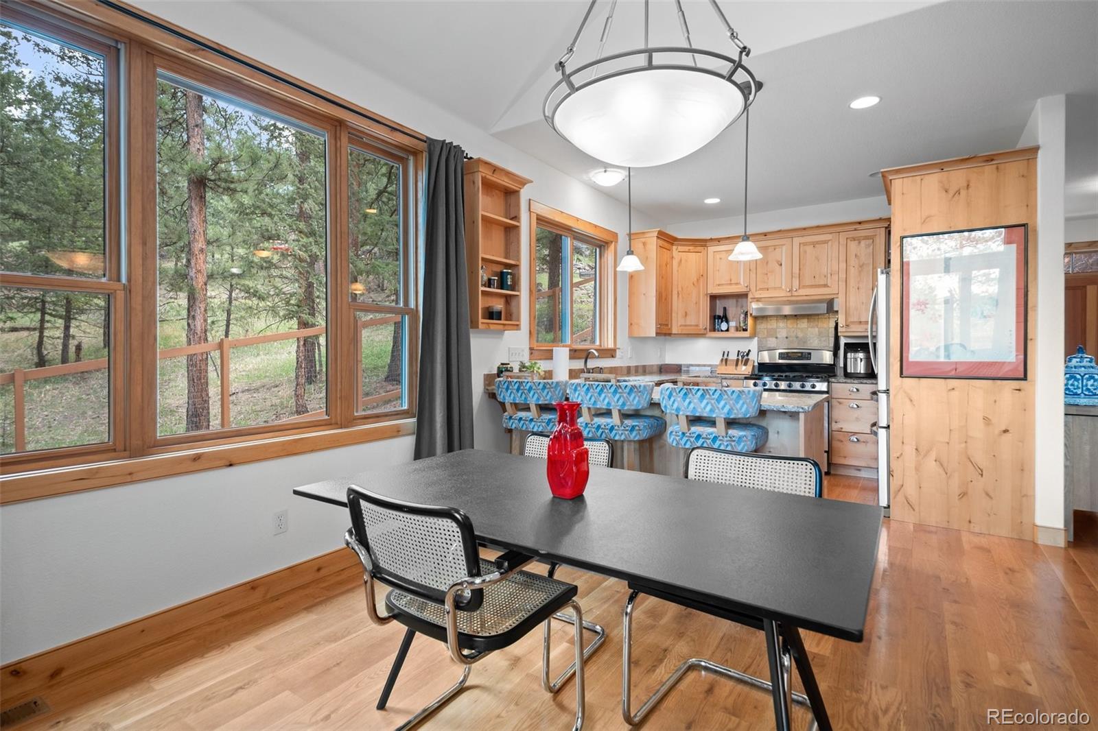 27711 Moffat Road Evergreen, CO 80439 - Photo 10 of 30 a dining room with furniture window and wooden floor