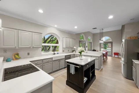 a large kitchen with a table and chairs