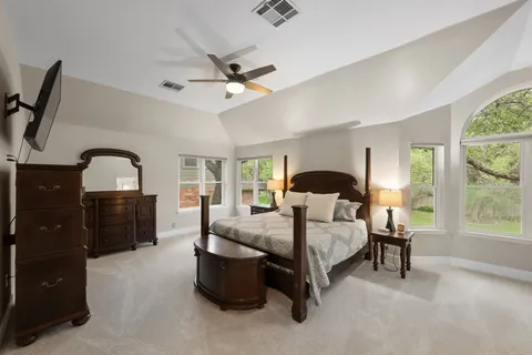 a bedroom with a bed and a chandelier