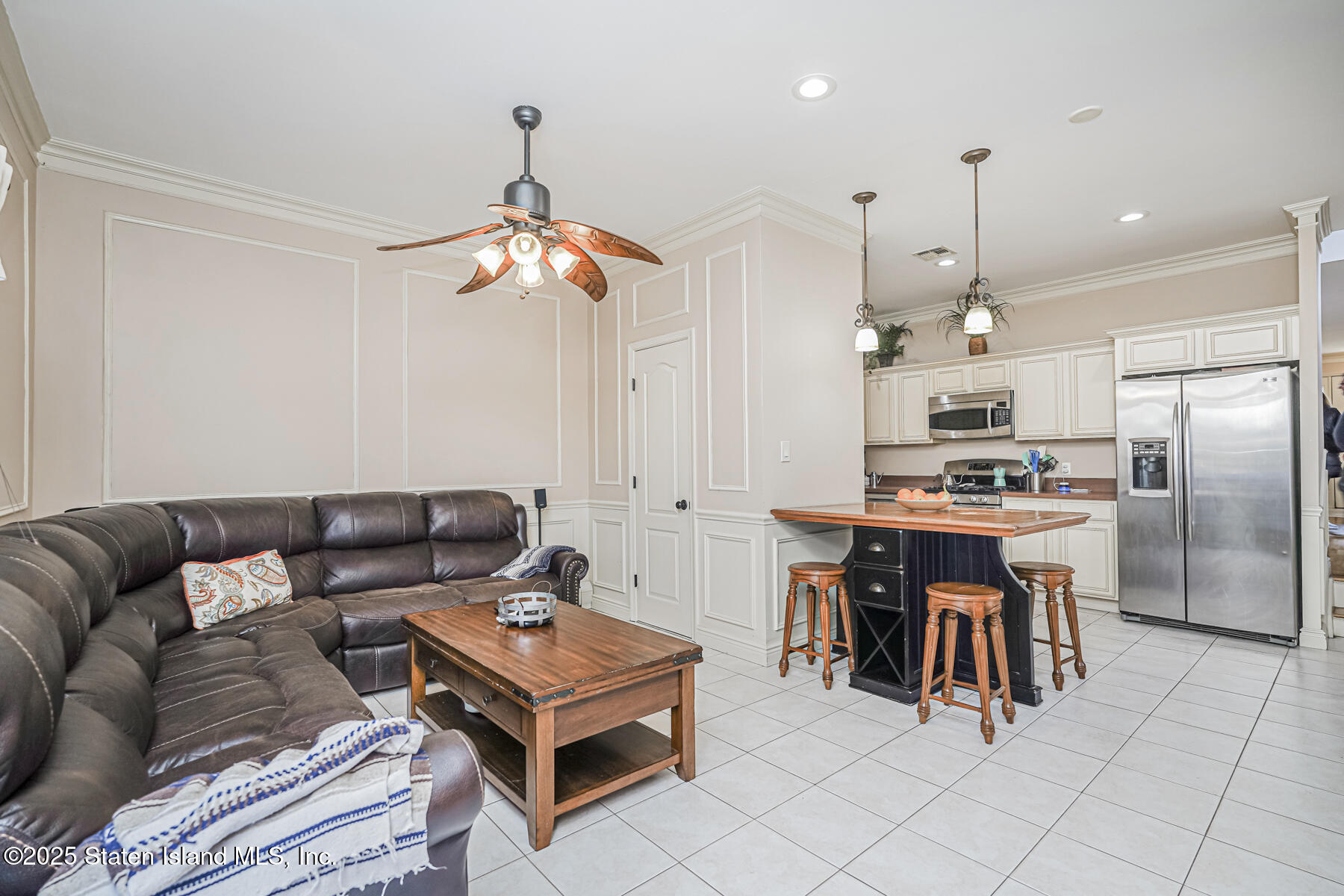 22 El Camino Loop Staten Island, NY 10309 - Photo 11 of 29 a living room with furniture a two kitchen and a chandelier