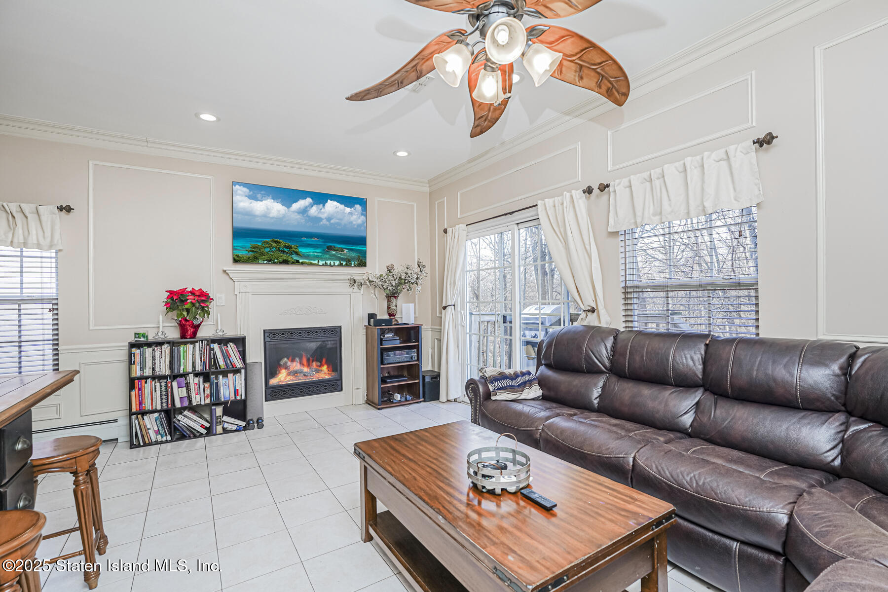 22 El Camino Loop Staten Island, NY 10309 - Photo 12 of 29 a living room with furniture a fireplace and a flat screen tv