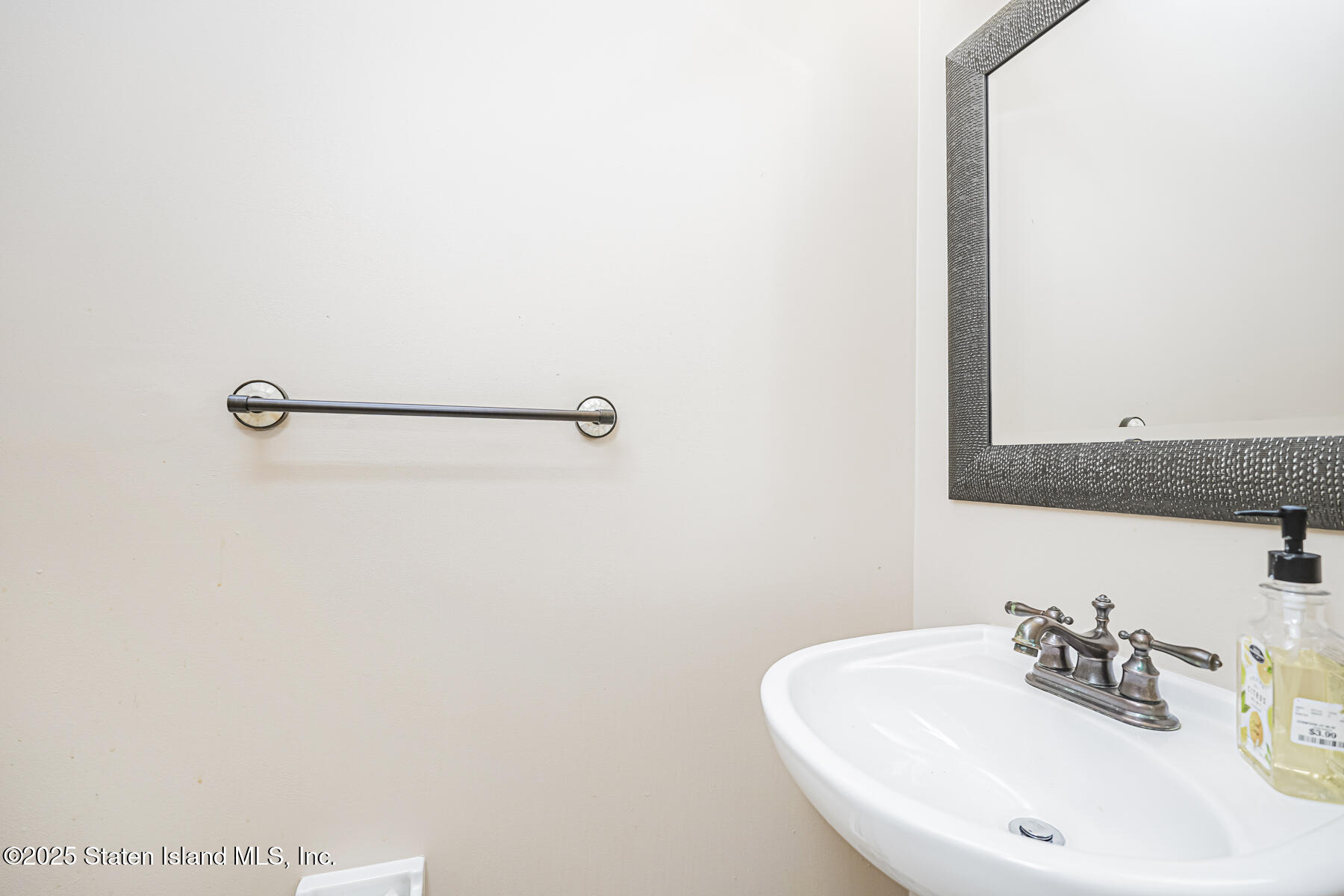 22 El Camino Loop Staten Island, NY 10309 - Photo 15 of 29 a bathroom with a sink and a mirror