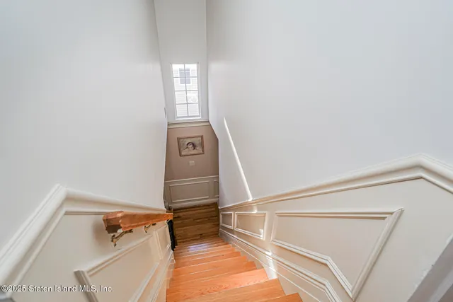 a view of entryway with stairs and wooden floor