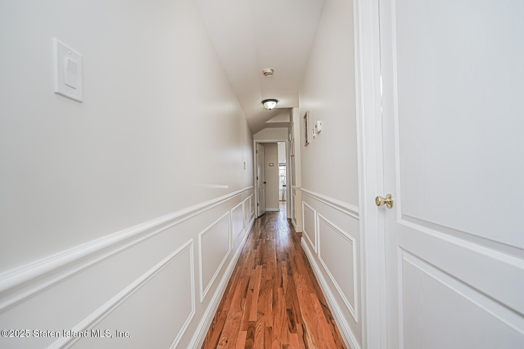 22 El Camino Loop Staten Island, NY 10309 - Photo 17 of 29 a view of a hallway with wooden floor and a bathroom