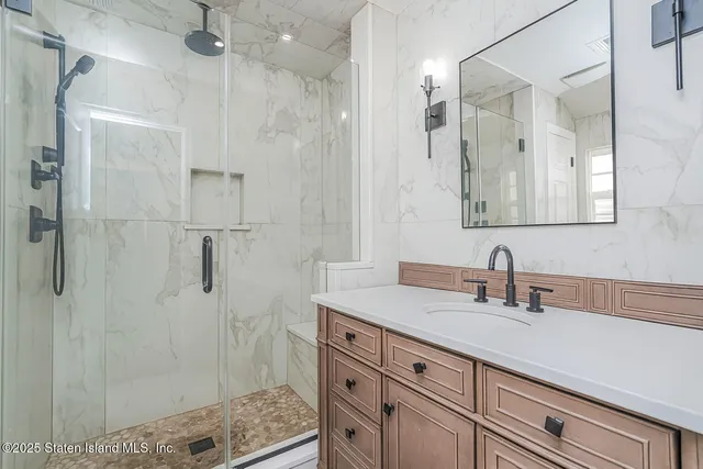 a bathroom with a shower sink and mirror