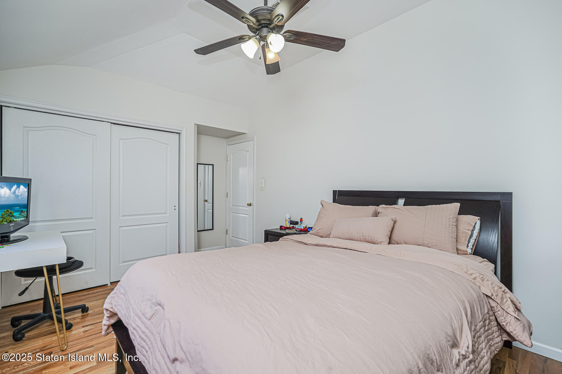 22 El Camino Loop Staten Island, NY 10309 - Photo 21 of 29 a bedroom with a bed and a chandelier