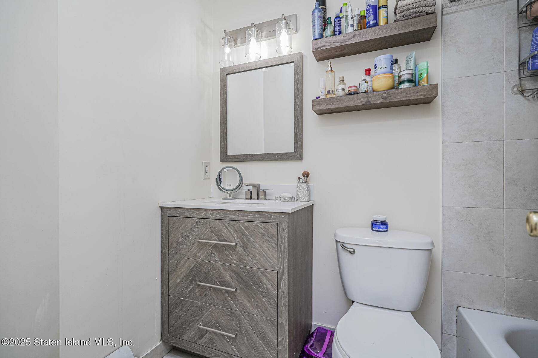 22 El Camino Loop Staten Island, NY 10309 - Photo 24 of 29 a bathroom with a toilet sink and mirror