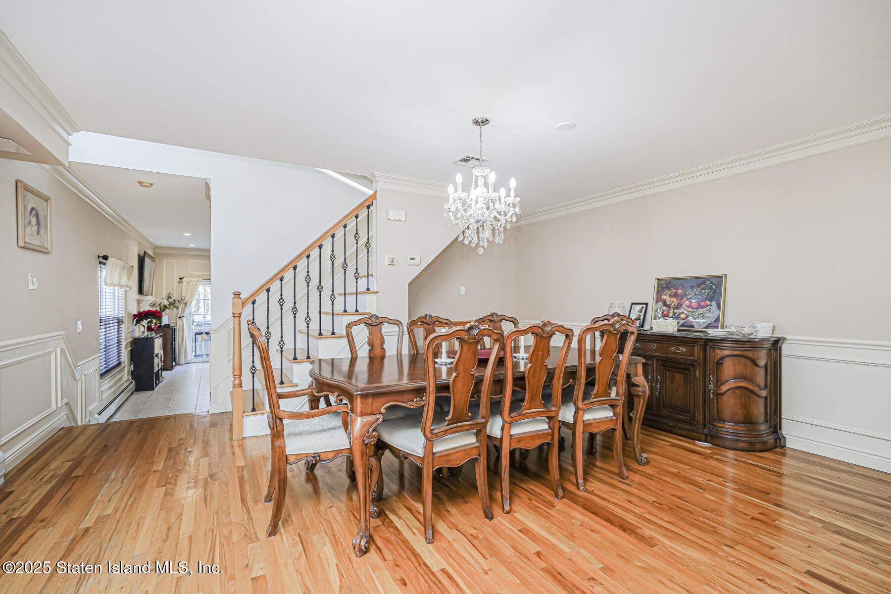 22 El Camino Loop Staten Island, NY 10309 - Photo 6 of 29 a dining room with furniture wooden floor clock and a chandelier