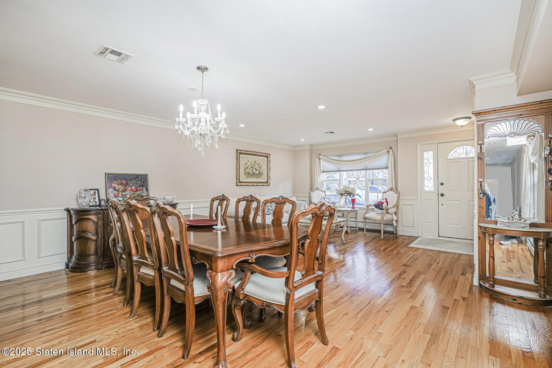 22 El Camino Loop Staten Island, NY 10309 - Photo 7 of 29 a dining room with furniture a chandelier and wooden floor