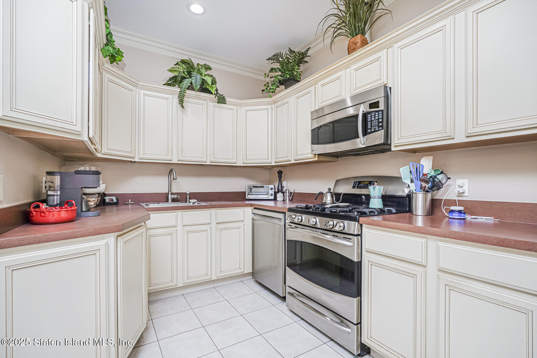 22 El Camino Loop Staten Island, NY 10309 - Photo 8 of 29 a kitchen with stainless steel appliances granite countertop white cabinets a stove a sink and dishwasher