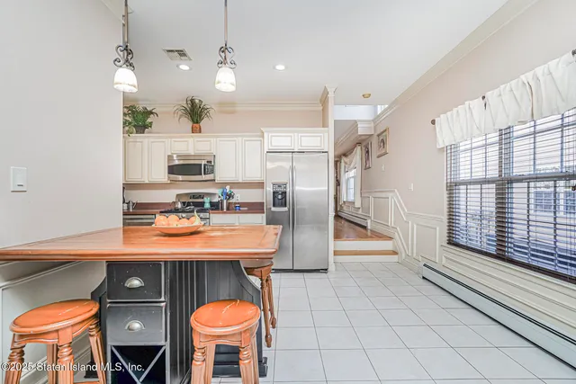 a kitchen with stainless steel appliances granite countertop a sink a stove and a refrigerator