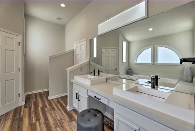 a bathroom with a tub and a window