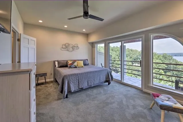 a bedroom with a large bed and a large window