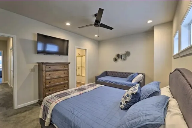 a bathroom with a granite countertop sink mirror and shower