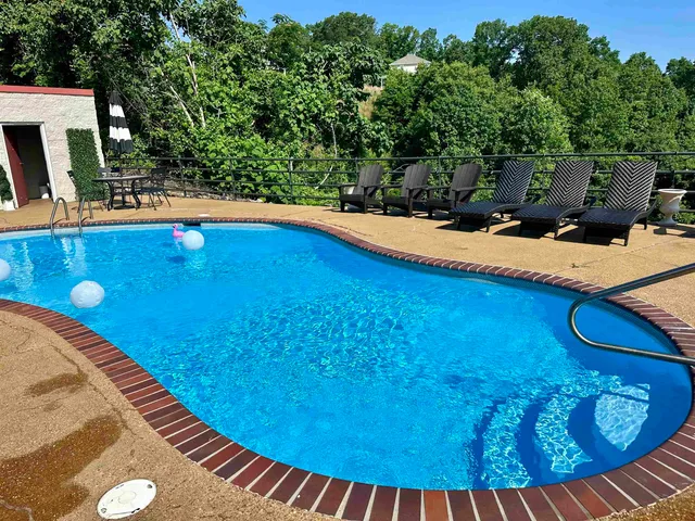 an aerial view of a house with swimming pool and glass doors
