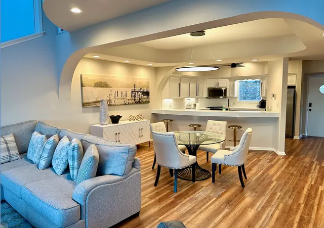 a dining room with furniture and wooden floor