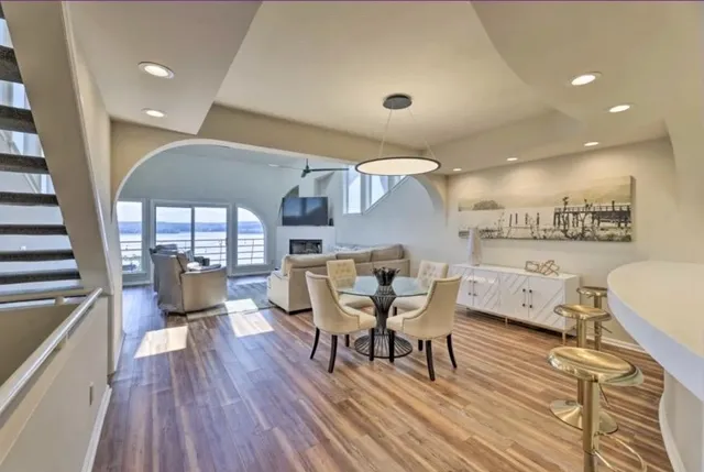 a kitchen with kitchen island granite countertop a sink stainless steel appliances and cabinets