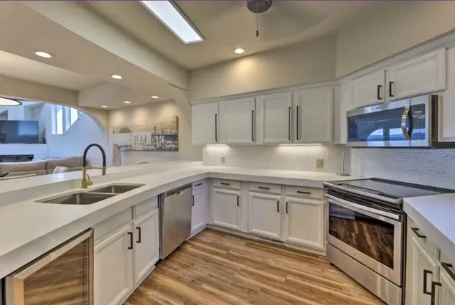 a large kitchen with a table and chairs