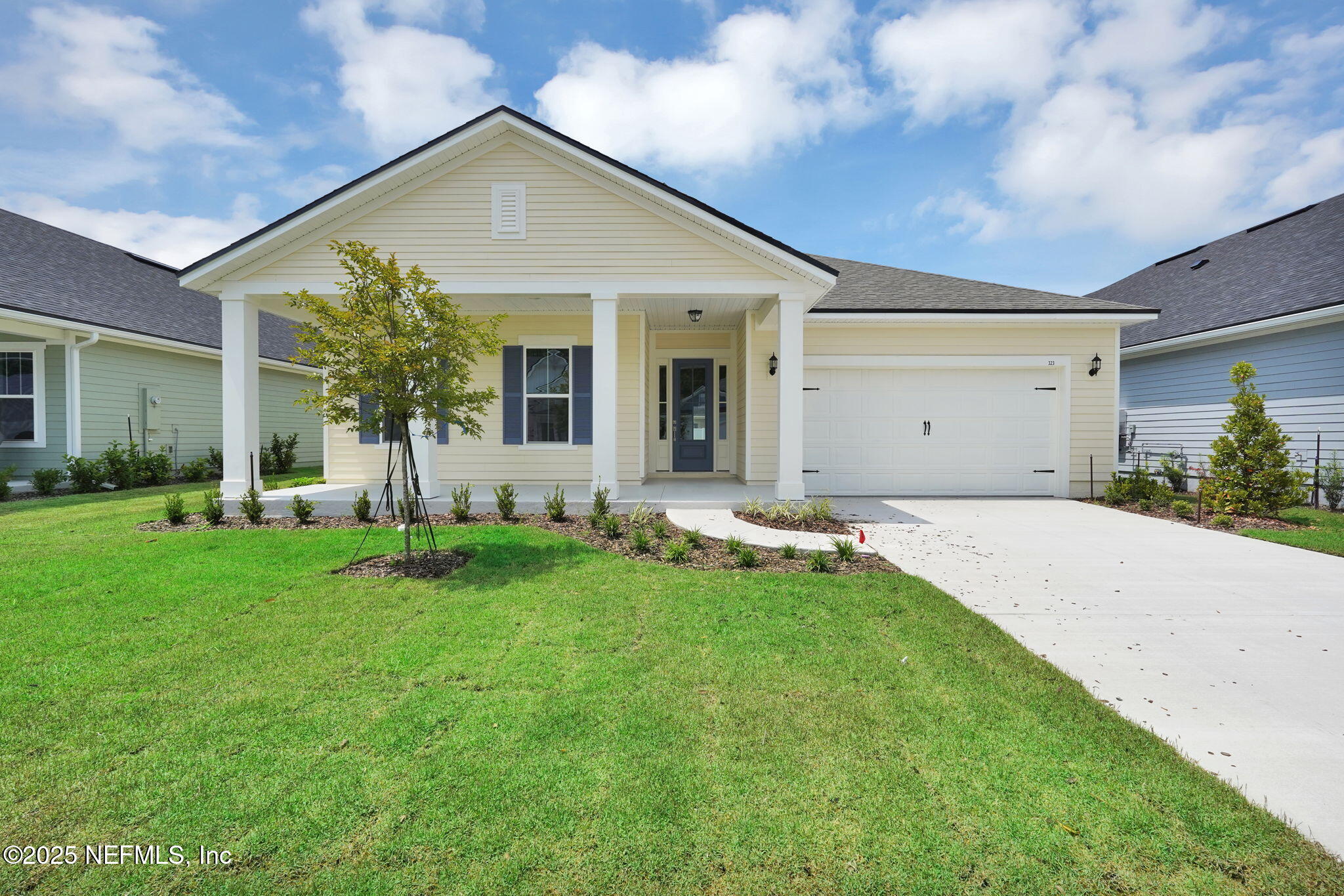 323 Sawgrass Drive Yulee, FL 32097 - Photo 2 of 48 a view of a house with a backyard and porch