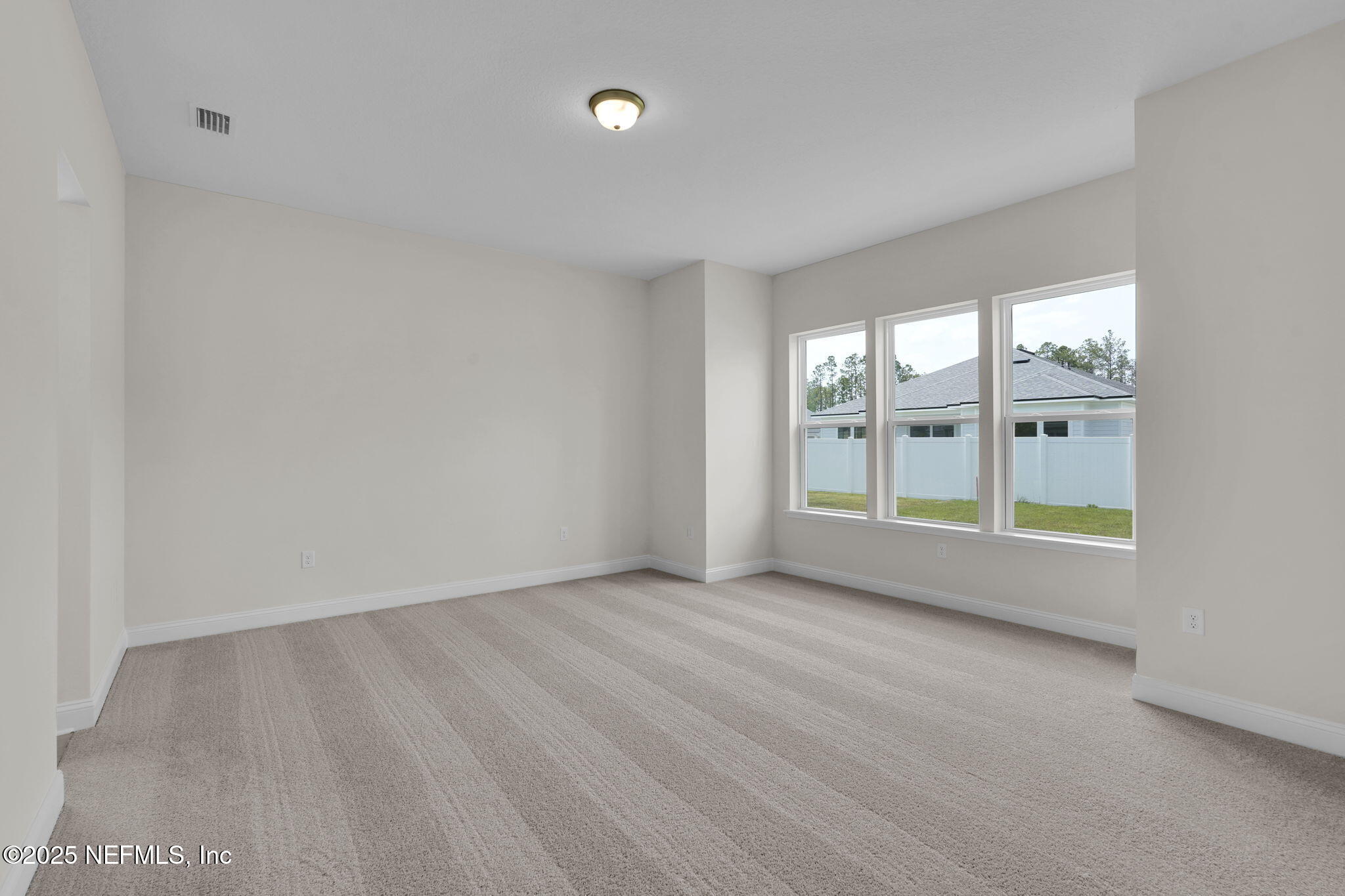 323 Sawgrass Drive Yulee, FL 32097 - Photo 26 of 48 wooden floor in an empty room with a window